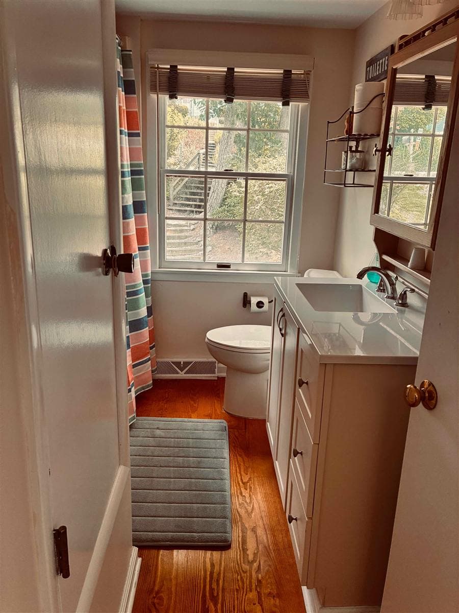 A bright, spotless bathroom with a clean toilet and white vanity after a YassClean visit in Branchville, NJ.