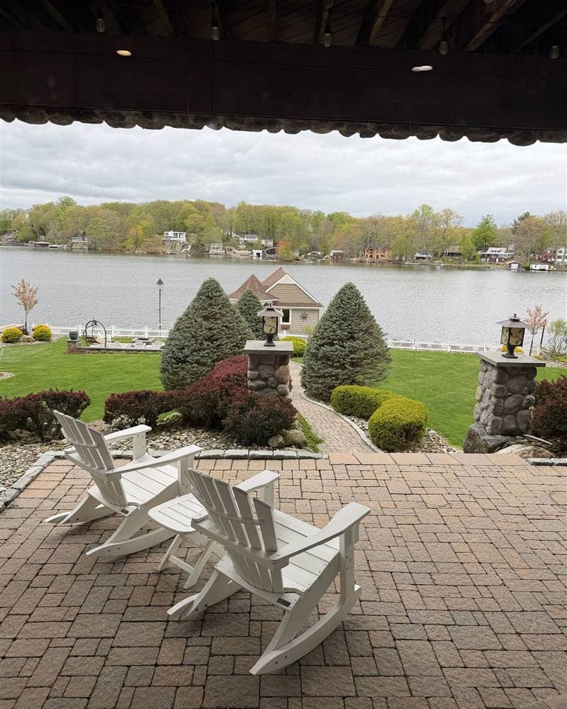 A pristine lakeside patio and landscaped yard at a premium New Jersey home serviced by a house cleaning company.