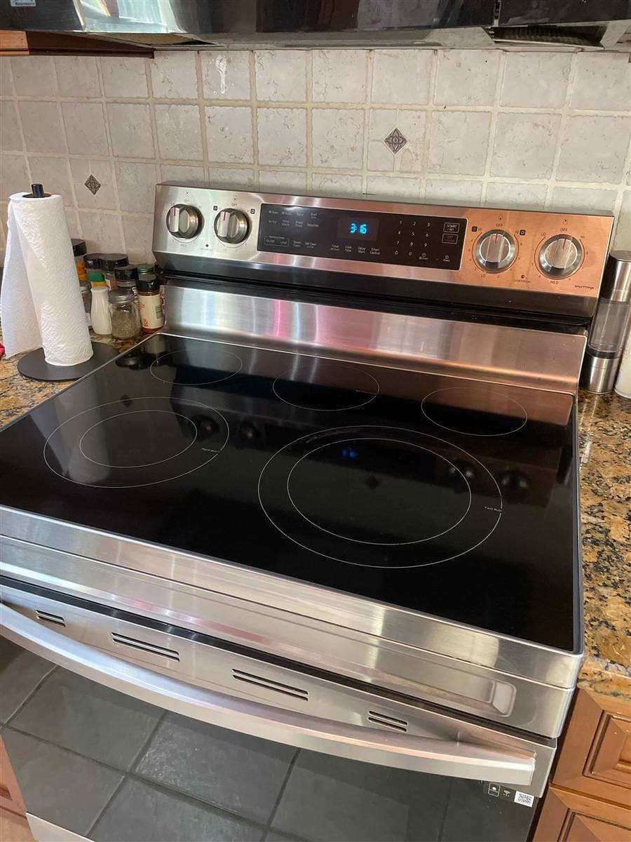Spotless glass cooktop and polished stainless range after cleaning in Branchville, NJ