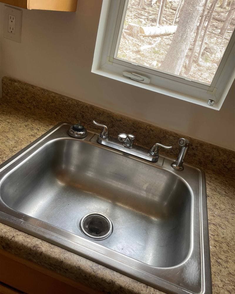 Polished stainless steel kitchen sink and faucet after cleaning in Hopatcong, NJ
