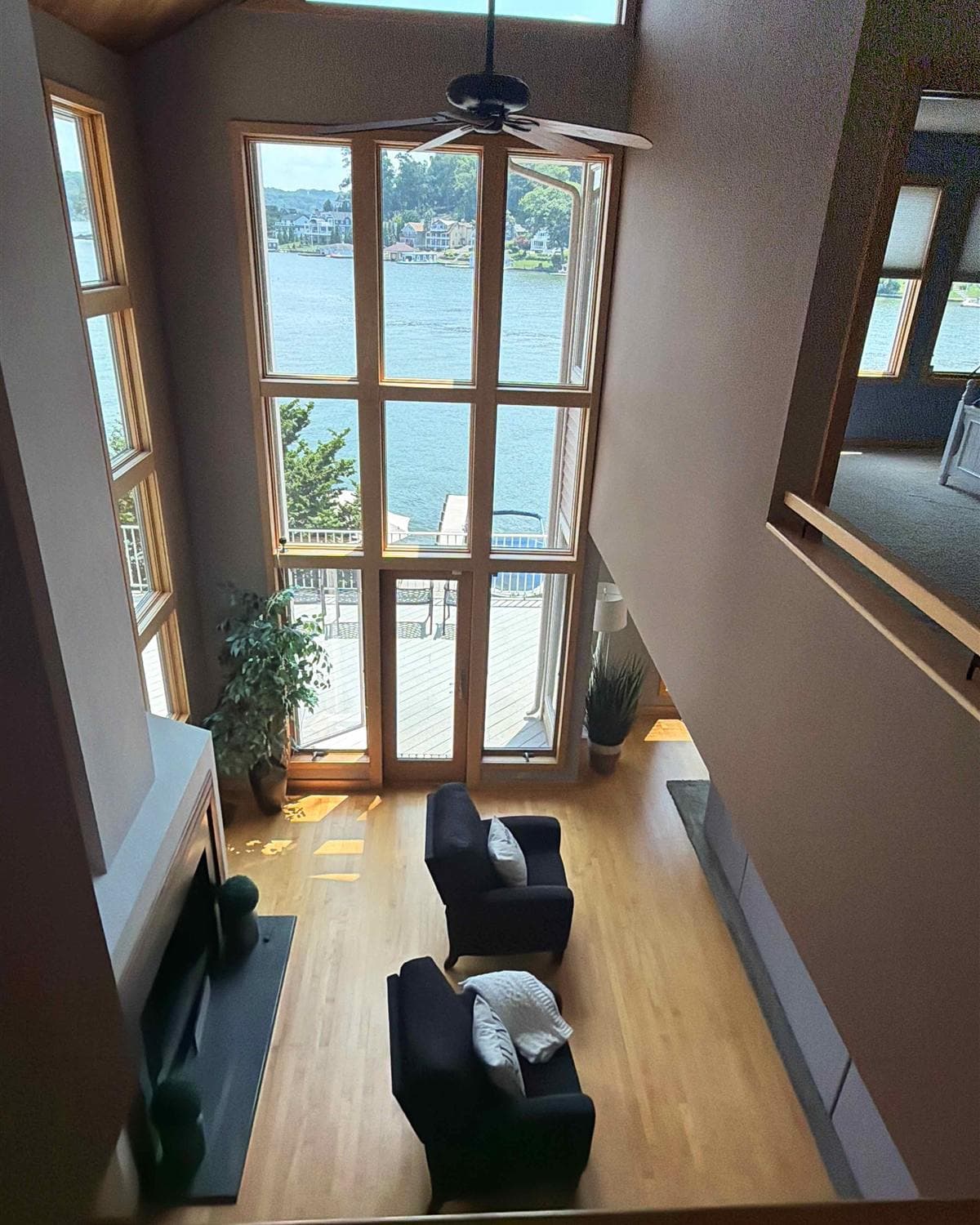 Freshly cleaned two-story living room with floor-to-ceiling windows overlooking Lake Hopatcong in Hopatcong, NJ