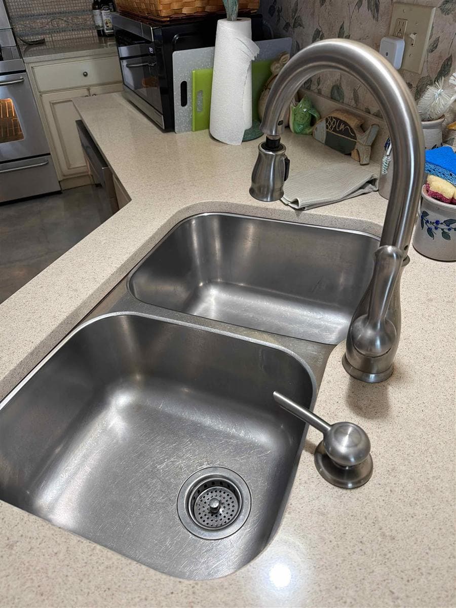 Gleaming stainless steel double kitchen sink and faucet after cleaning in Hopatcong, NJ