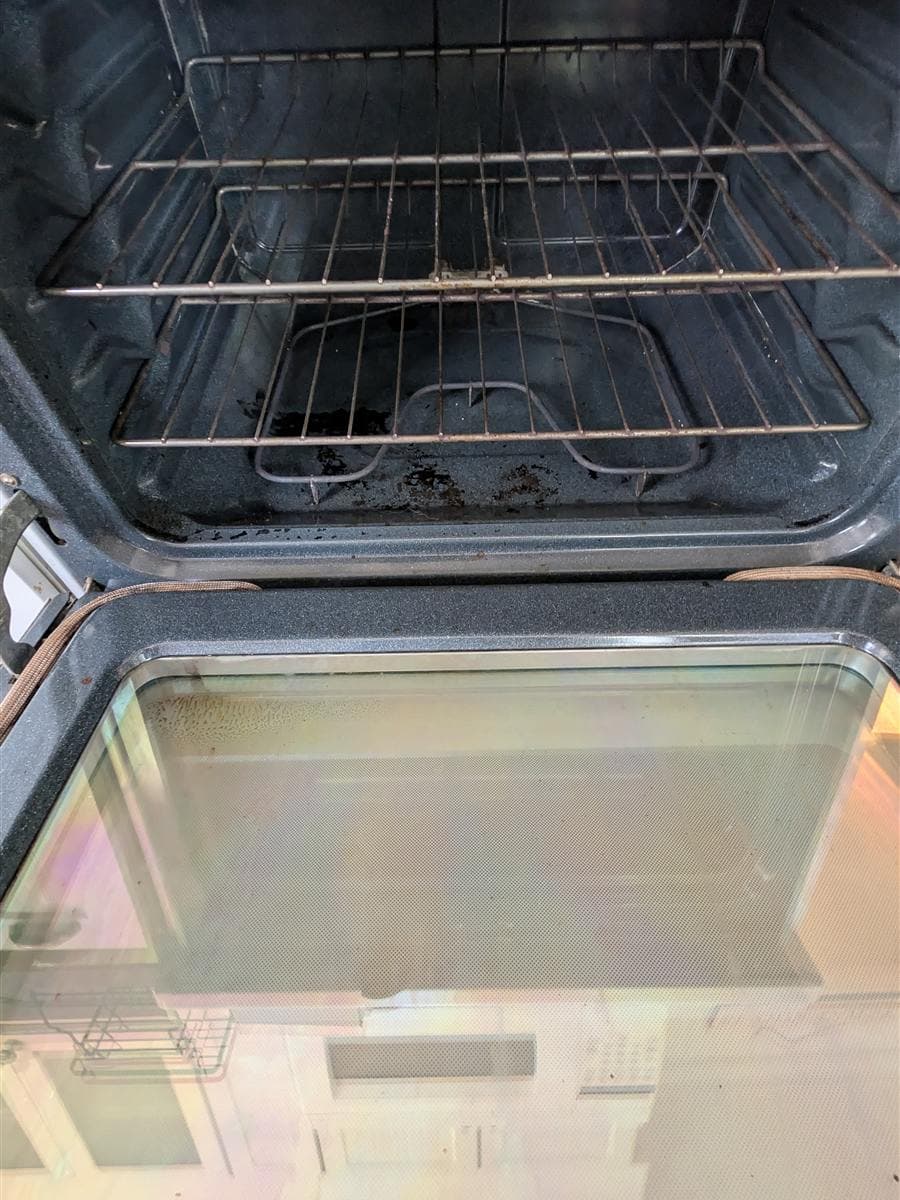 Oven interior with baked-on grime before deep cleaning in Mount Arlington, NJ