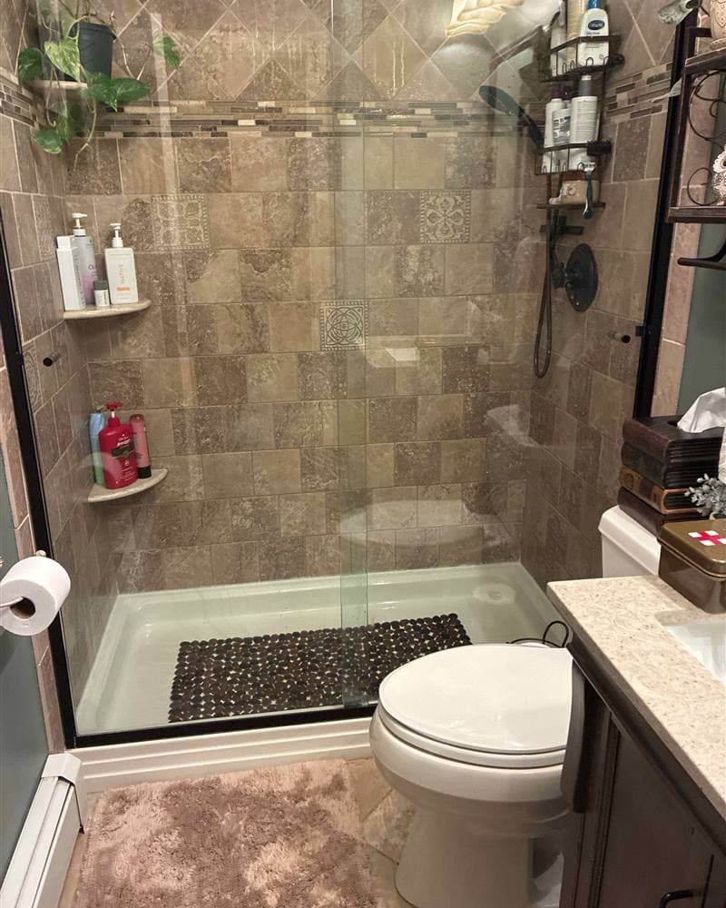 Cleaned tiled walk-in shower with glass door and toilet in Mount Olive, NJ