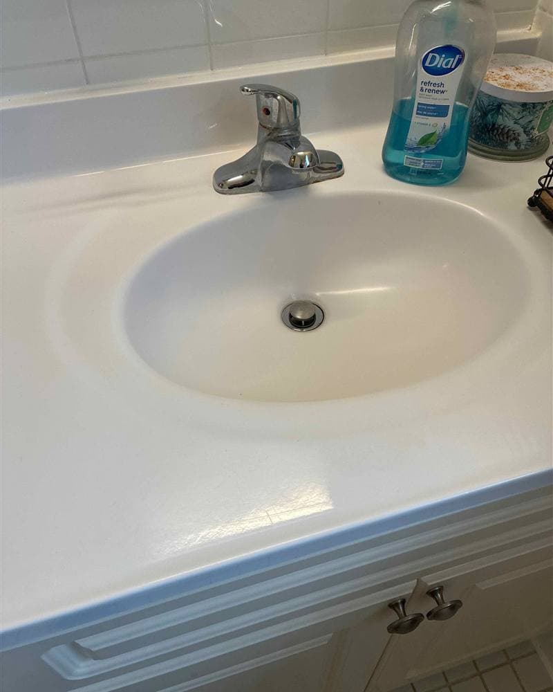 Polished white bathroom sink and chrome faucet after cleaning in Mount Olive, NJ