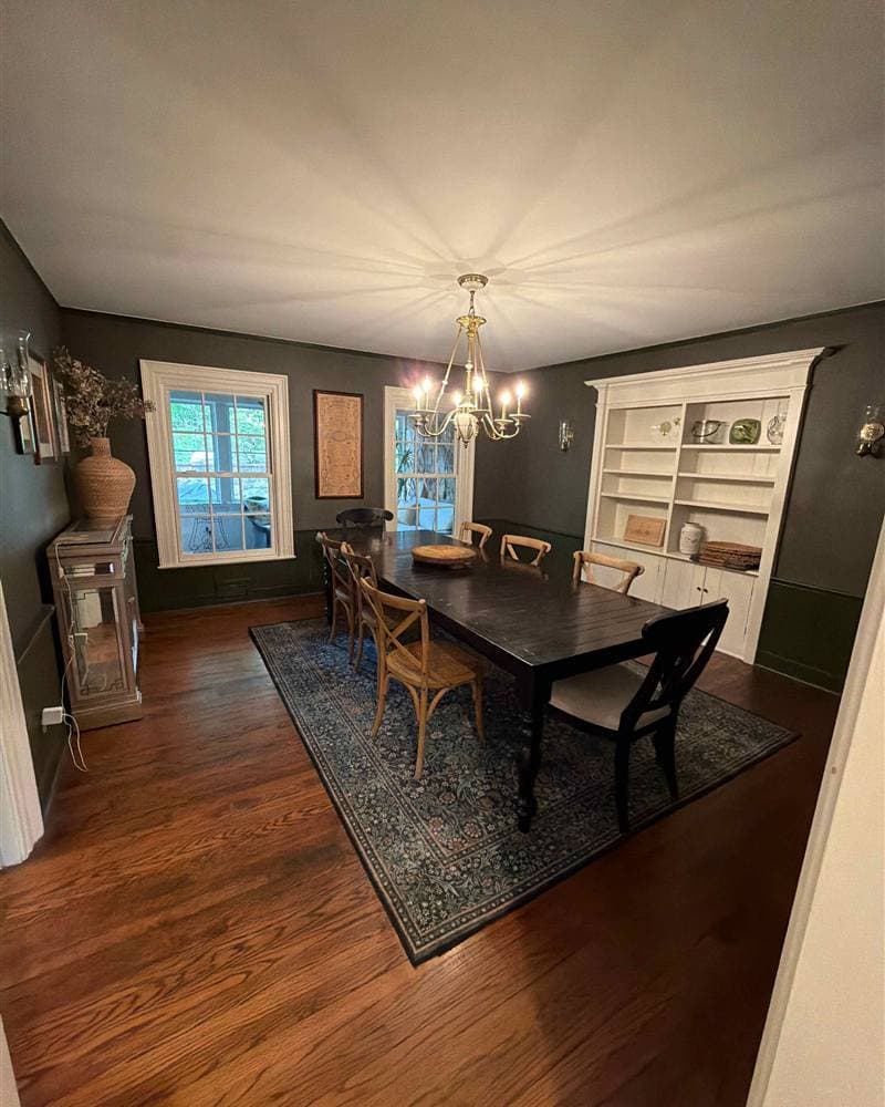 Dining room with dark wood table, area rug, and white built-in hutch after cleaning in Mountain Lakes, NJ