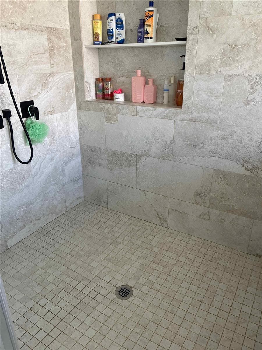 Tiled walk-in shower with clean floor, walls, and niche after cleaning in Newton, NJ