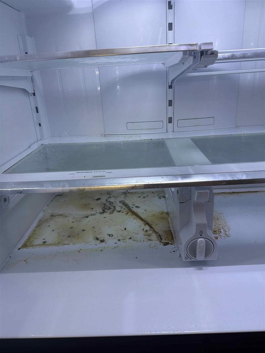 Refrigerator interior with spills and buildup before cleaning in Roxbury, NJ