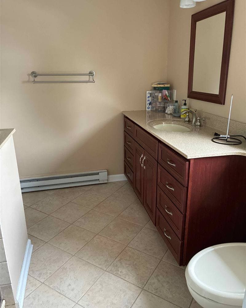 Cleaned bathroom vanity with granite countertop and tile floor in a Sparta, NJ home