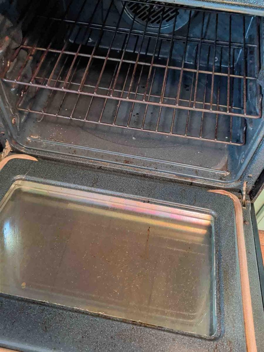 Oven interior and door glass with baked-on grime before cleaning in a Stanhope, NJ kitchen