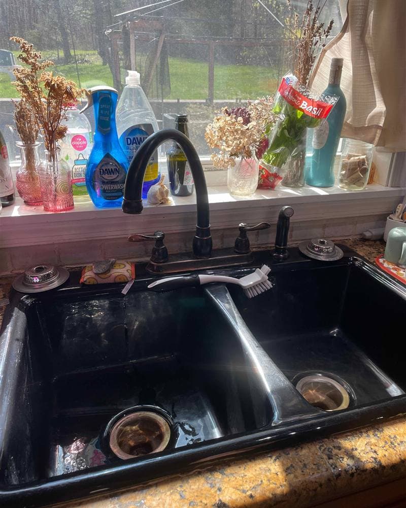 Clean double kitchen sink and bronze faucet in a sunlit Branchville, NJ kitchen
