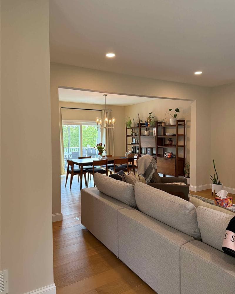 Freshly cleaned open living room and dining area with hardwood floors in a Jefferson, NJ home