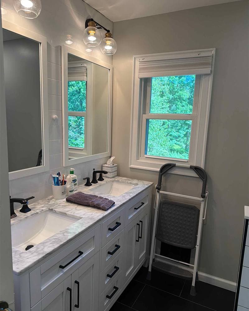 Clean double vanity bathroom with marble countertop and framed mirrors in Rockaway, NJ