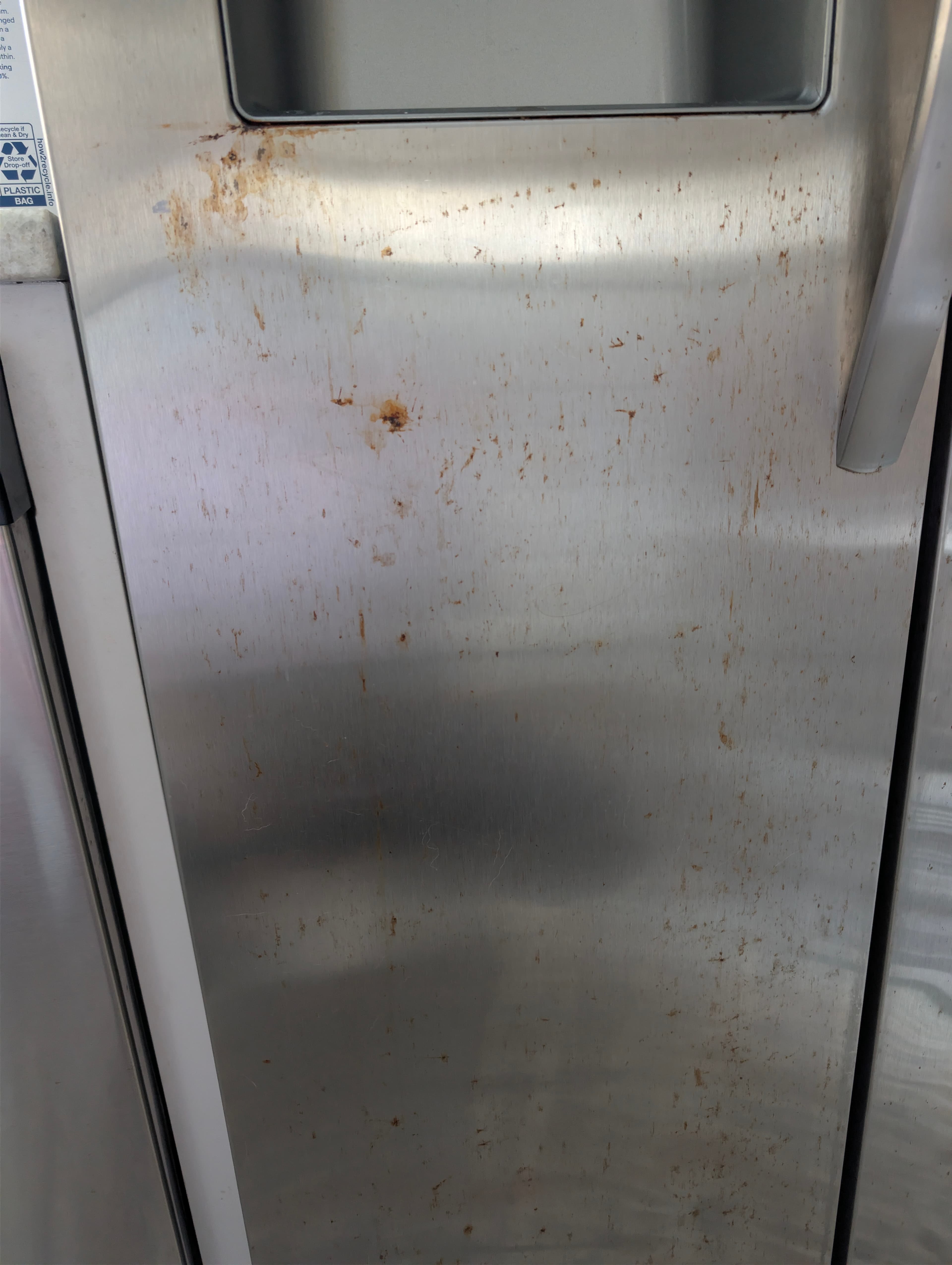 Dirty stainless steel fridge before YassClean